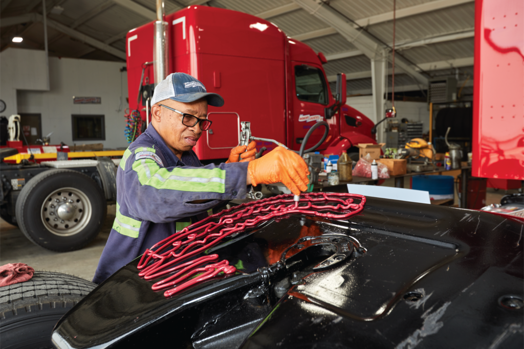 Andrews Logistics maintenance technician servicing a tractor in the company shop